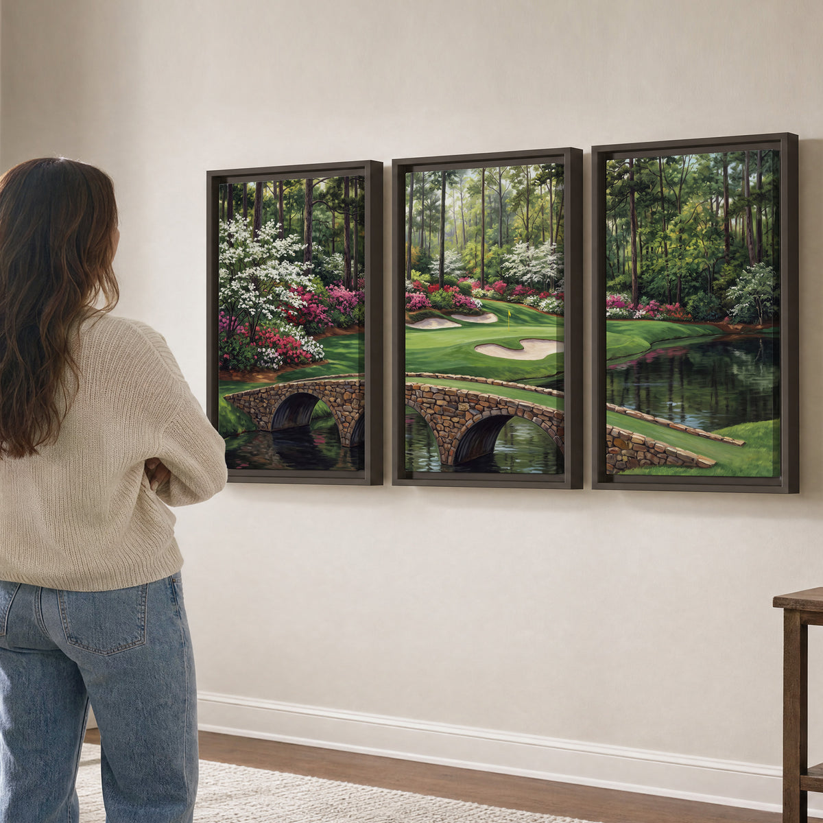 An arched stone bridge beside a landscaped golf course and reflective pond 3 piece framed canvas wall art three panel arrangement on a wall
