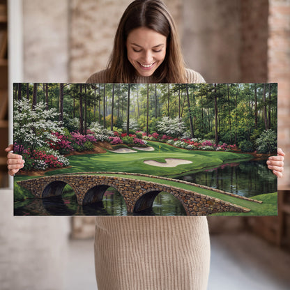 An arched stone bridge beside a landscaped golf course and reflective pond single canvas wall art held in hands