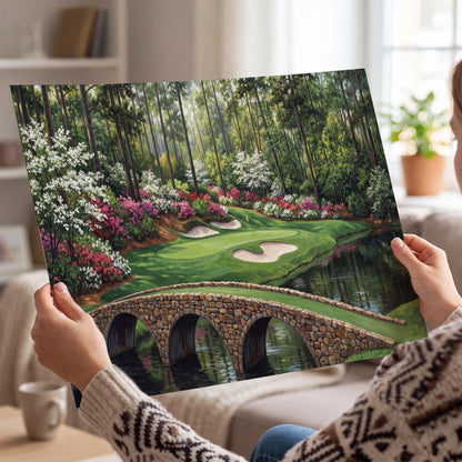 An arched stone bridge beside a landscaped golf course and reflective pond single poster print held in hands