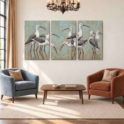 Long-legged white and gray wading birds against a muted aqua background 3 piece canvas wall art styled in an interior