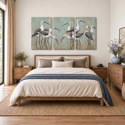 Long-legged white and gray wading birds against a muted aqua background 3 piece canvas wall art styled in an interior