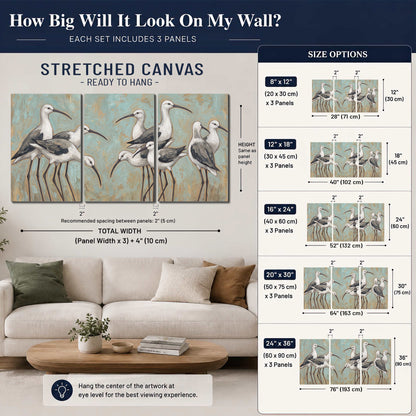 Long-legged white and gray wading birds against a muted aqua background 3 piece canvas wall art size guide above a sofa; room view is illustrative