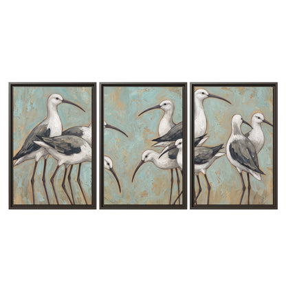 Long-legged white and gray wading birds against a muted aqua background 3 piece framed canvas wall art viewed straight on