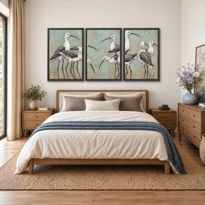 Long-legged white and gray wading birds against a muted aqua background 3 piece framed canvas wall art styled in an interior