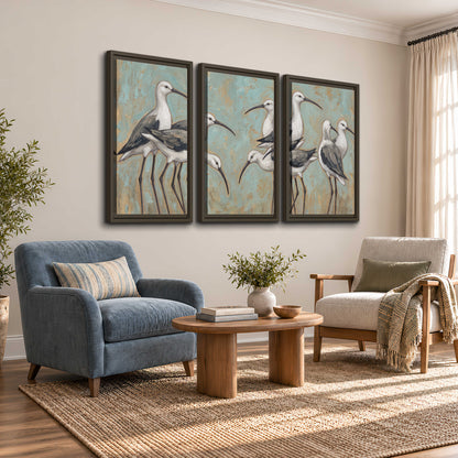 Long-legged white and gray wading birds against a muted aqua background 3 piece framed canvas wall art styled in an interior