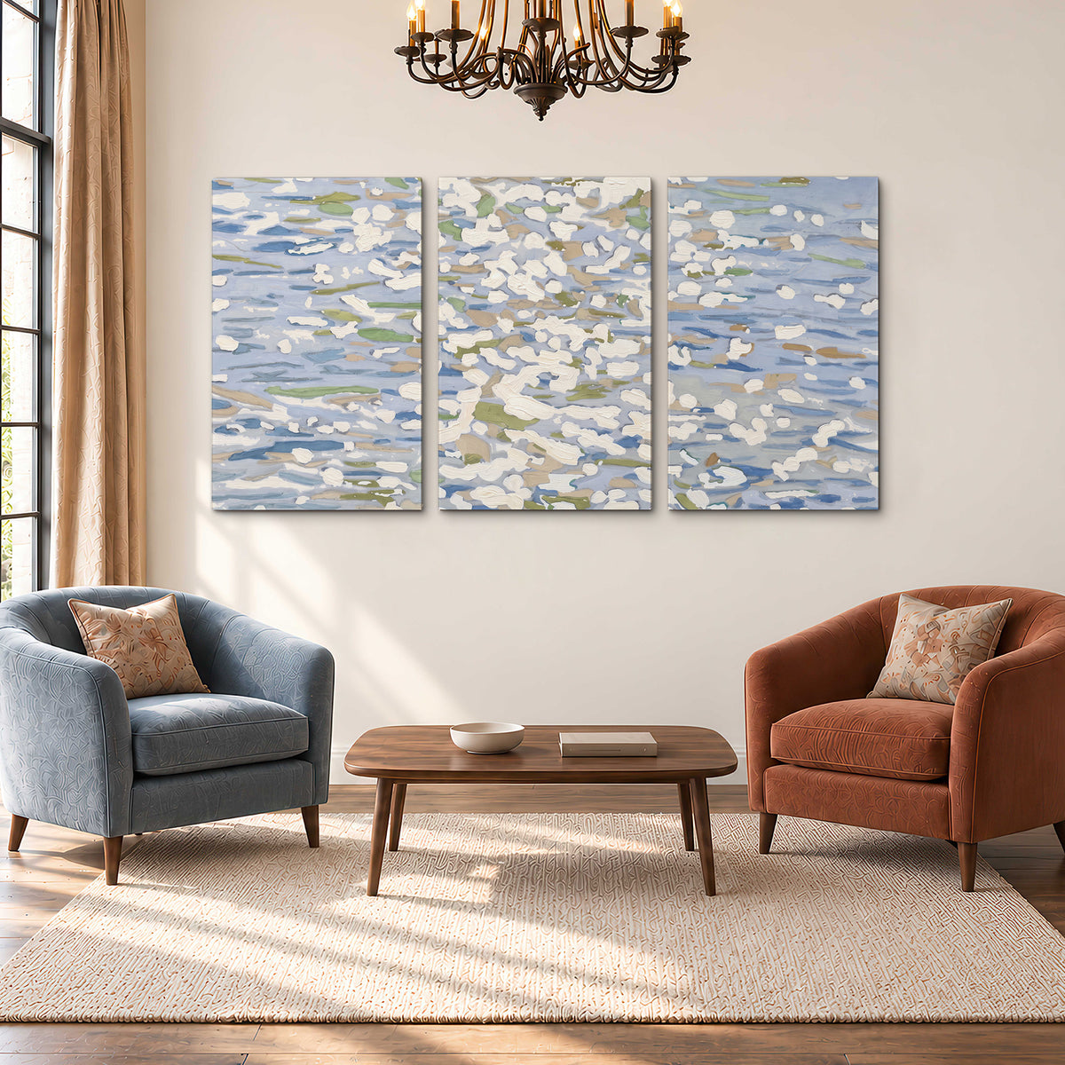 Loose pale blue, white and soft green marks suggesting shimmering water 3 piece canvas wall art styled in an interior