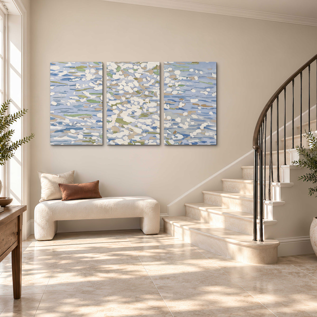 Loose pale blue, white and soft green marks suggesting shimmering water 3 piece canvas wall art styled in an interior