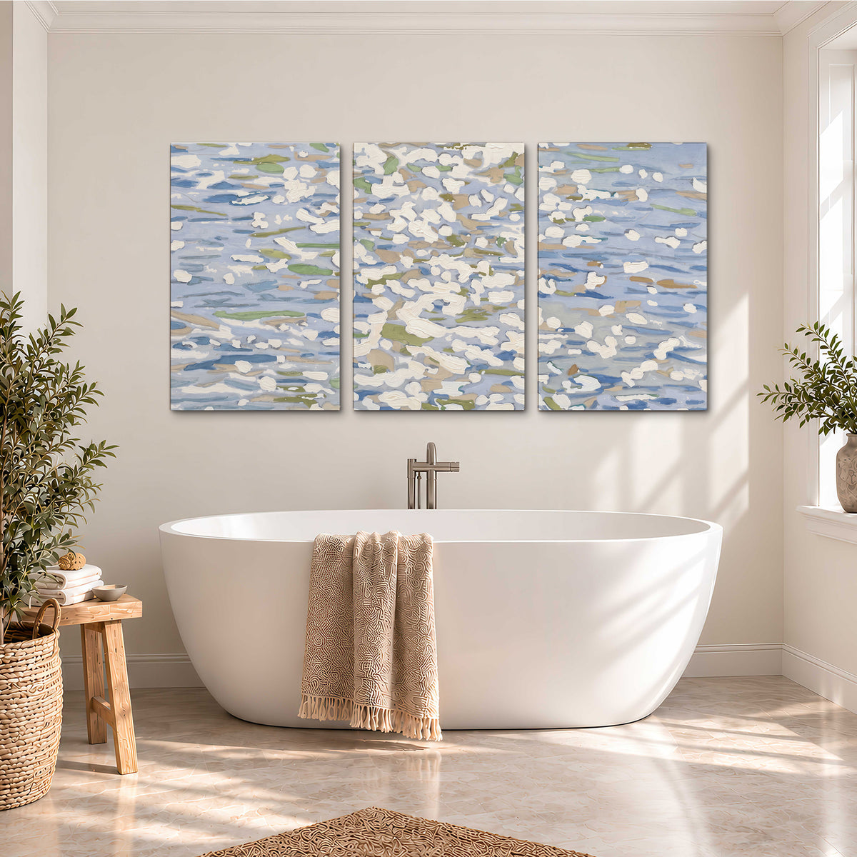 Loose pale blue, white and soft green marks suggesting shimmering water 3 piece canvas wall art styled in an interior
