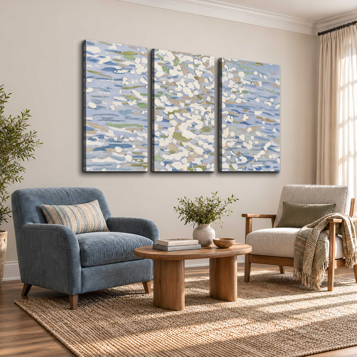 Loose pale blue, white and soft green marks suggesting shimmering water 3 piece canvas wall art styled in an interior