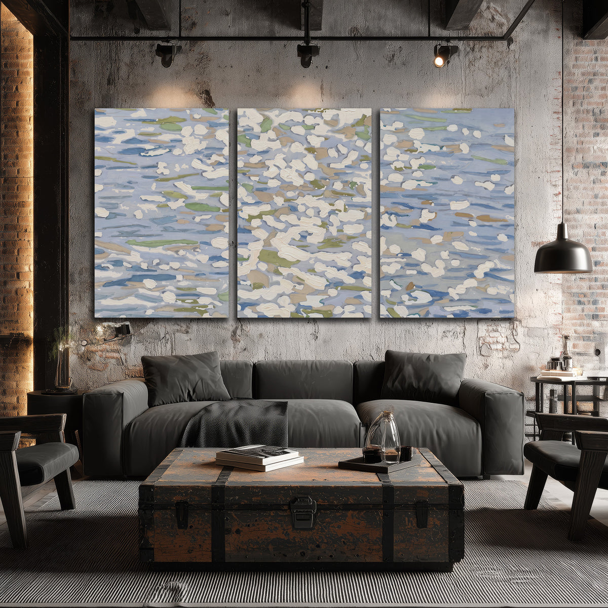 Loose pale blue, white and soft green marks suggesting shimmering water 3 piece canvas wall art displayed in a industrial room