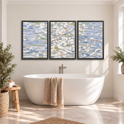 Loose pale blue, white and soft green marks suggesting shimmering water 3 piece framed canvas wall art styled in an interior