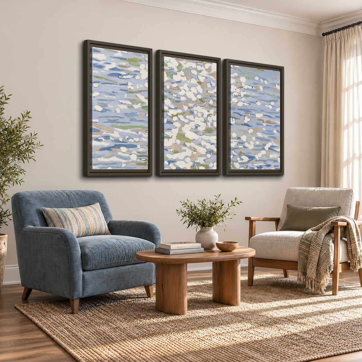 Loose pale blue, white and soft green marks suggesting shimmering water 3 piece framed canvas wall art styled in an interior