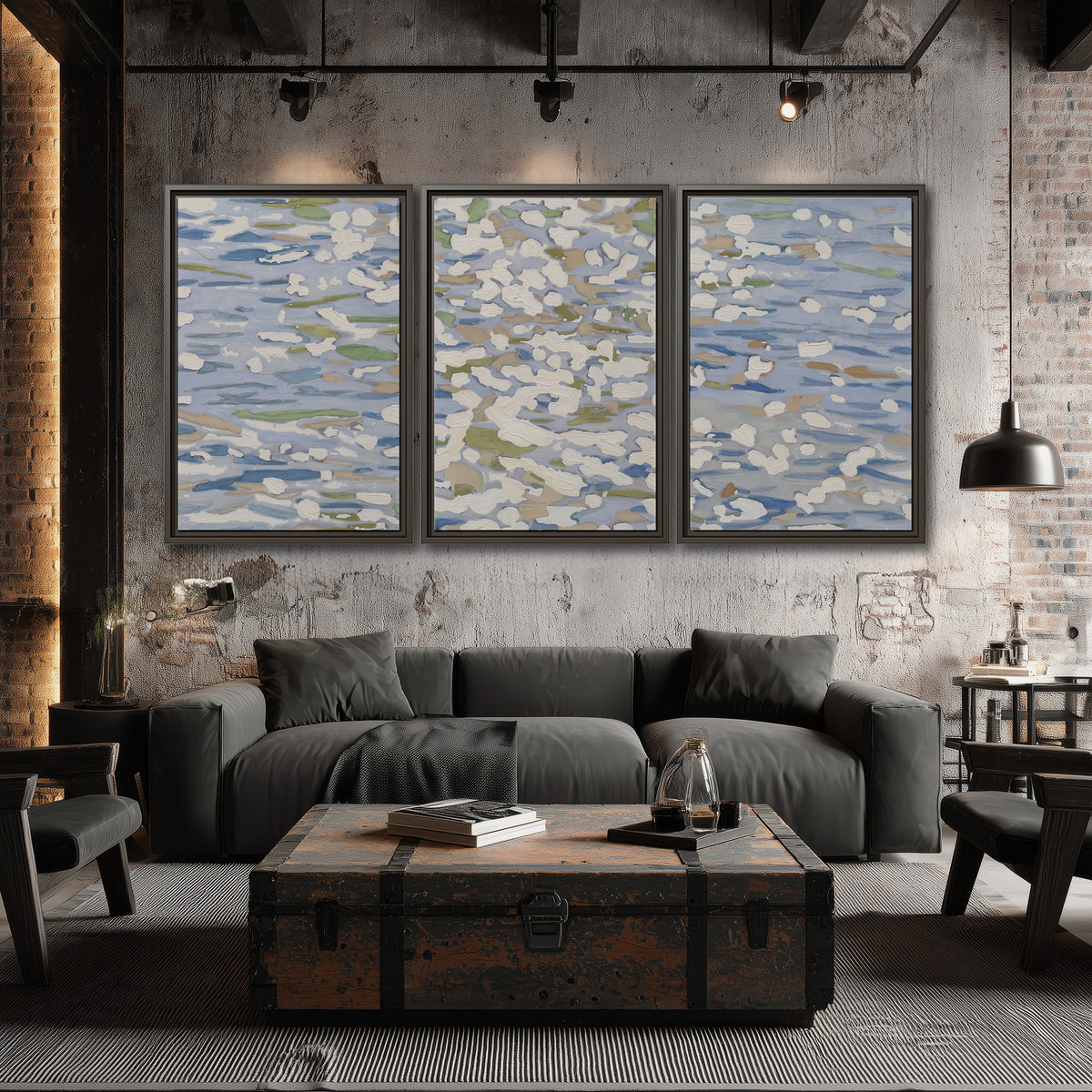 Loose pale blue, white and soft green marks suggesting shimmering water 3 piece framed canvas wall art displayed in a industrial room
