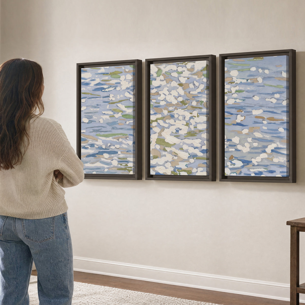Loose pale blue, white and soft green marks suggesting shimmering water 3 piece framed canvas wall art three panel arrangement on a wall