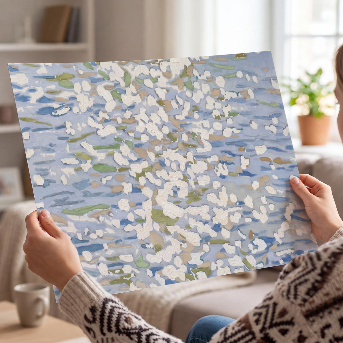 Loose pale blue, white and soft green marks suggesting shimmering water single poster print held in hands