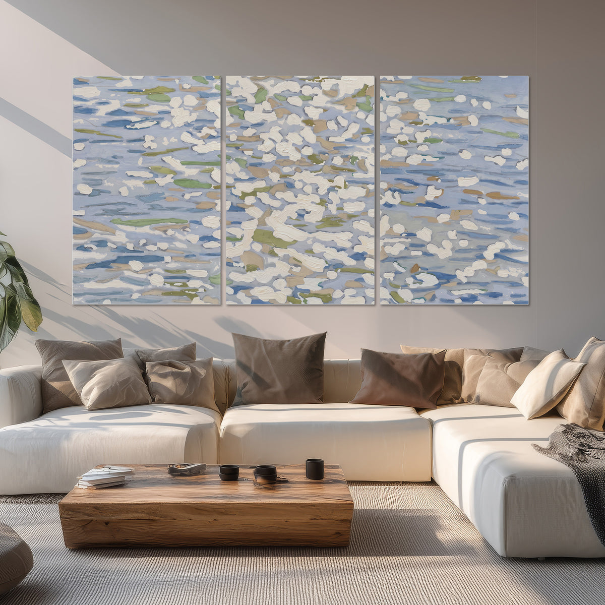 Loose pale blue, white and soft green marks suggesting shimmering water set of 3 poster prints displayed in a living room