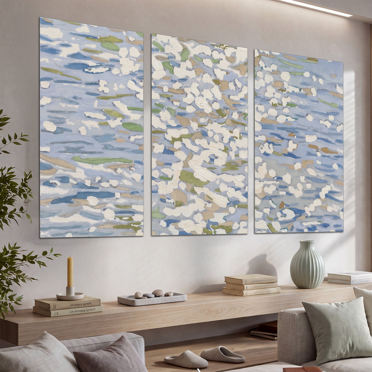 Loose pale blue, white and soft green marks suggesting shimmering water set of 3 poster prints displayed in a console