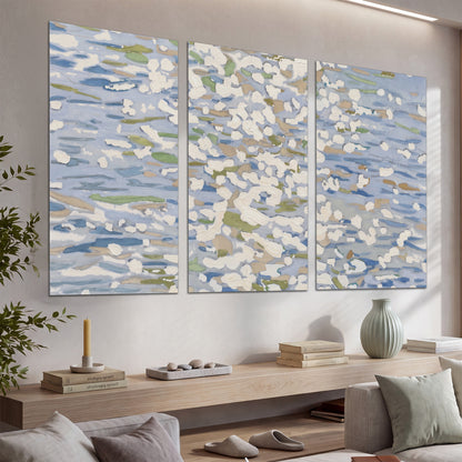 Loose pale blue, white and soft green marks suggesting shimmering water set of 3 poster prints displayed in a console