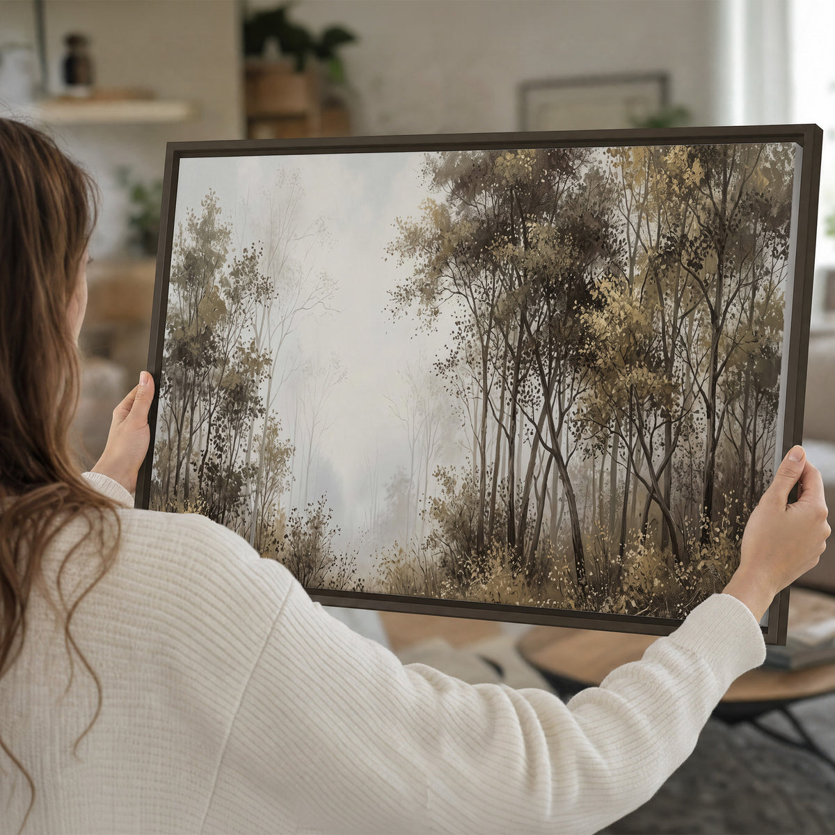 Tall autumn trees framing a pale misty woodland clearing single framed canvas wall art held in hands