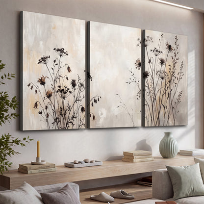Fine dark wildflower stems and seed heads against soft beige 3 piece canvas wall art displayed in a console