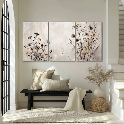 Fine dark wildflower stems and seed heads against soft beige 3 piece canvas wall art displayed in a entryway