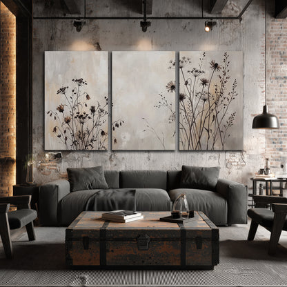 Fine dark wildflower stems and seed heads against soft beige 3 piece canvas wall art displayed in a industrial room