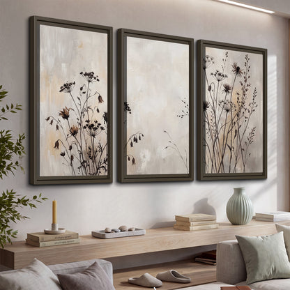 Fine dark wildflower stems and seed heads against soft beige 3 piece framed canvas wall art displayed in a console