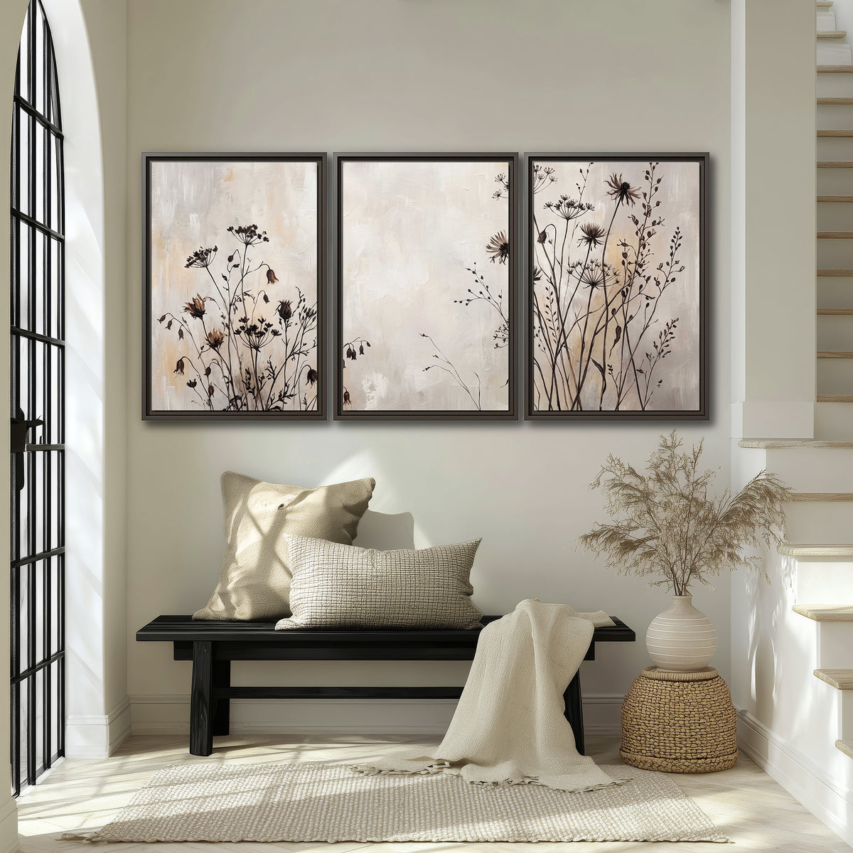 Fine dark wildflower stems and seed heads against soft beige 3 piece framed canvas wall art displayed in a entryway