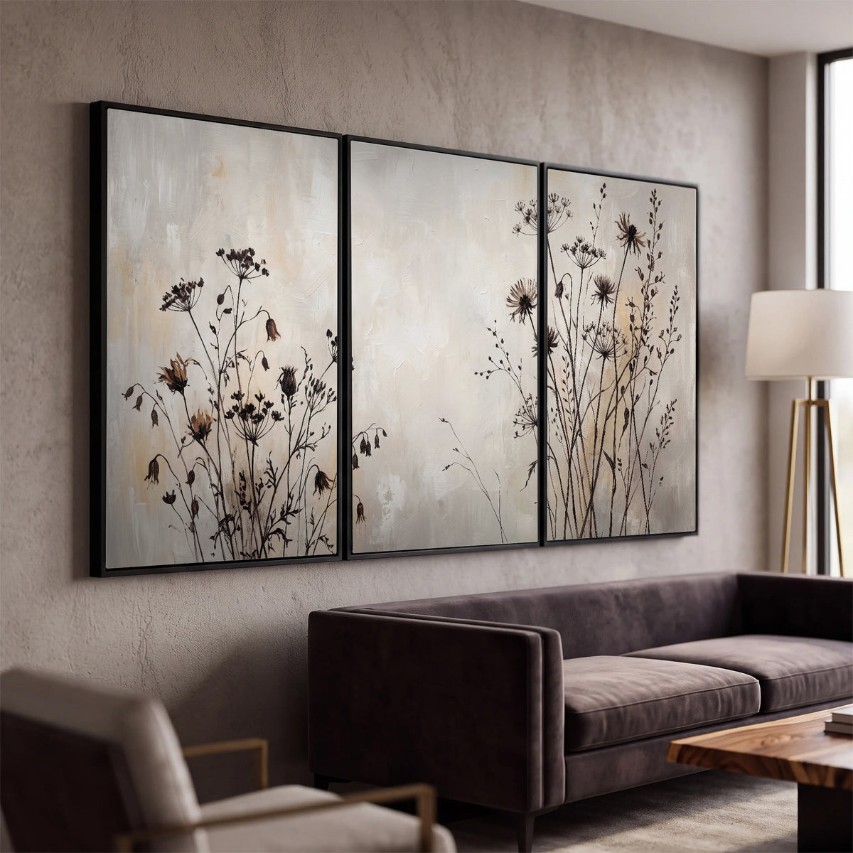 Fine dark wildflower stems and seed heads against soft beige 3 piece framed canvas wall art displayed in a modern living room