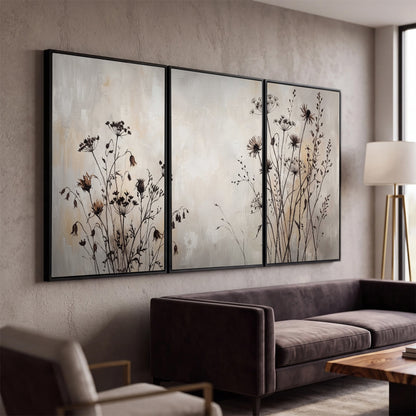 Fine dark wildflower stems and seed heads against soft beige 3 piece framed canvas wall art displayed in a modern living room