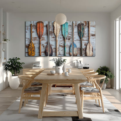 A row of colorful weathered wooden oars against pale blue boards 3 piece canvas wall art room and product view