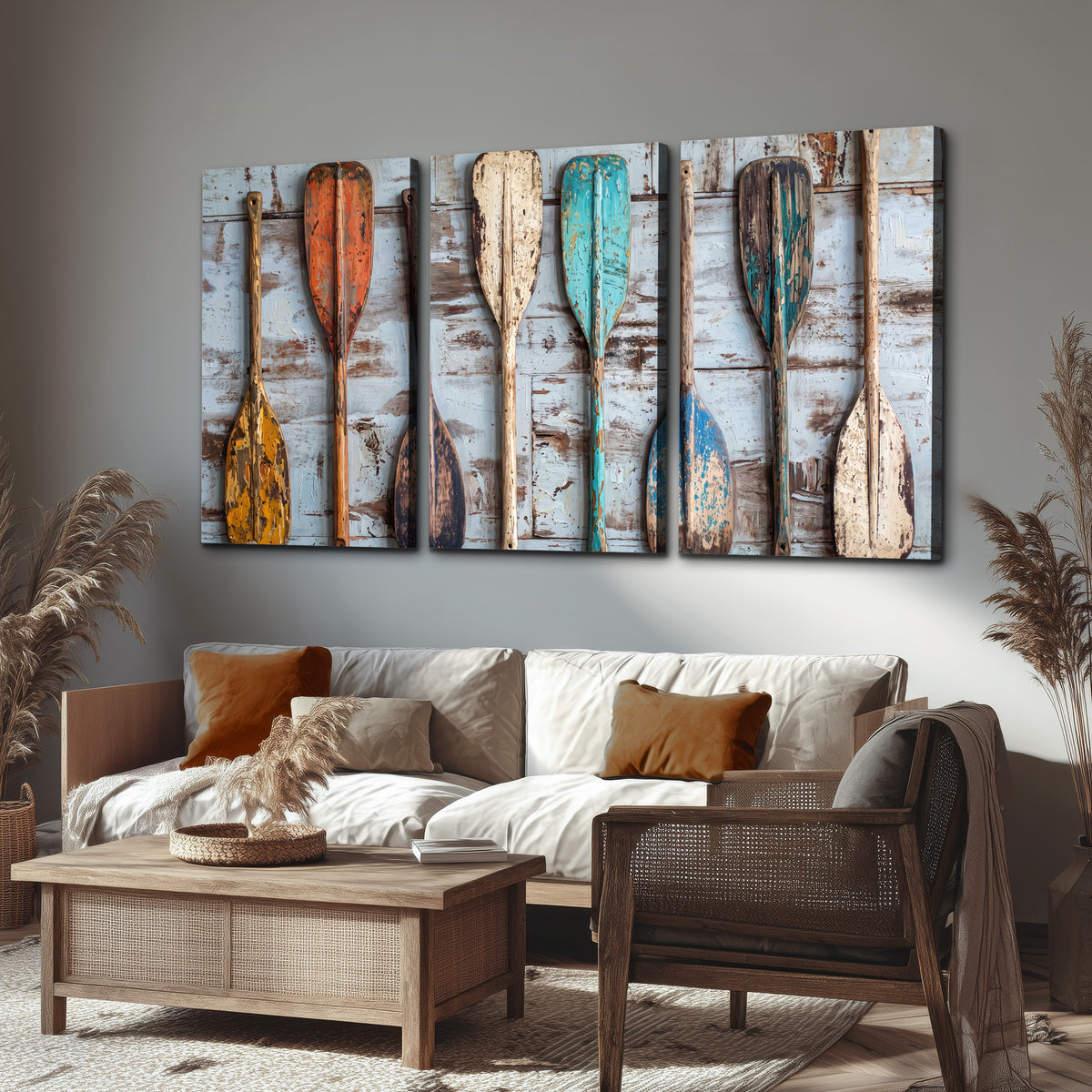 A row of colorful weathered wooden oars against pale blue boards 3 piece canvas wall art displayed in a rustic living room