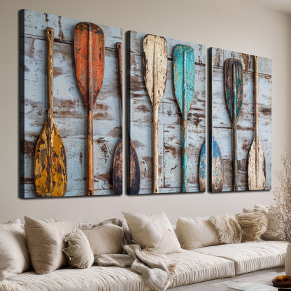 A row of colorful weathered wooden oars against pale blue boards 3 piece canvas wall art room and product view