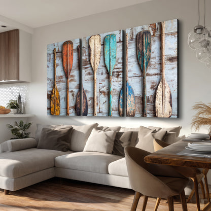 A row of colorful weathered wooden oars against pale blue boards 3 piece canvas wall art room and product view