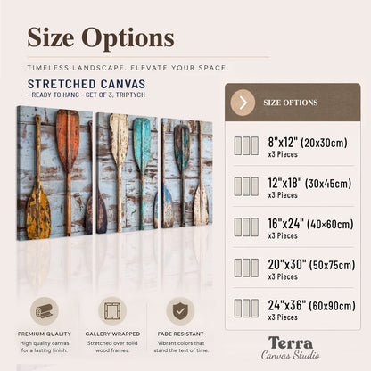 A row of colorful weathered wooden oars against pale blue boards 3 piece canvas wall art available dimensions; triptych dimensions are per panel