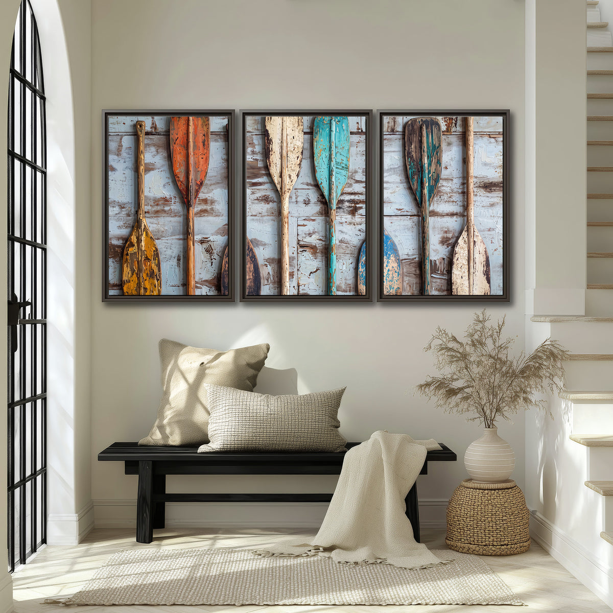 A row of colorful weathered wooden oars against pale blue boards 3 piece framed canvas wall art displayed in a entryway