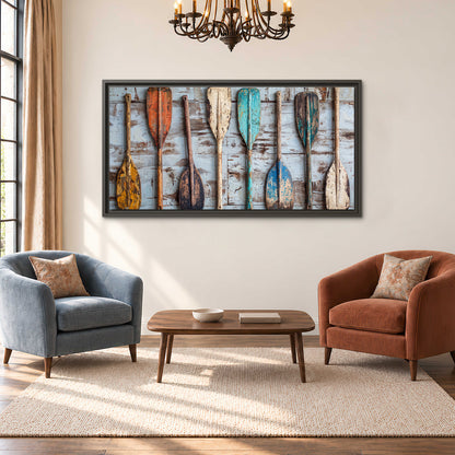 A row of colorful weathered wooden oars against pale blue boards single framed canvas wall art styled in an interior