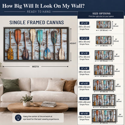 A row of colorful weathered wooden oars against pale blue boards single framed canvas wall art size guide above a sofa; room view is illustrative