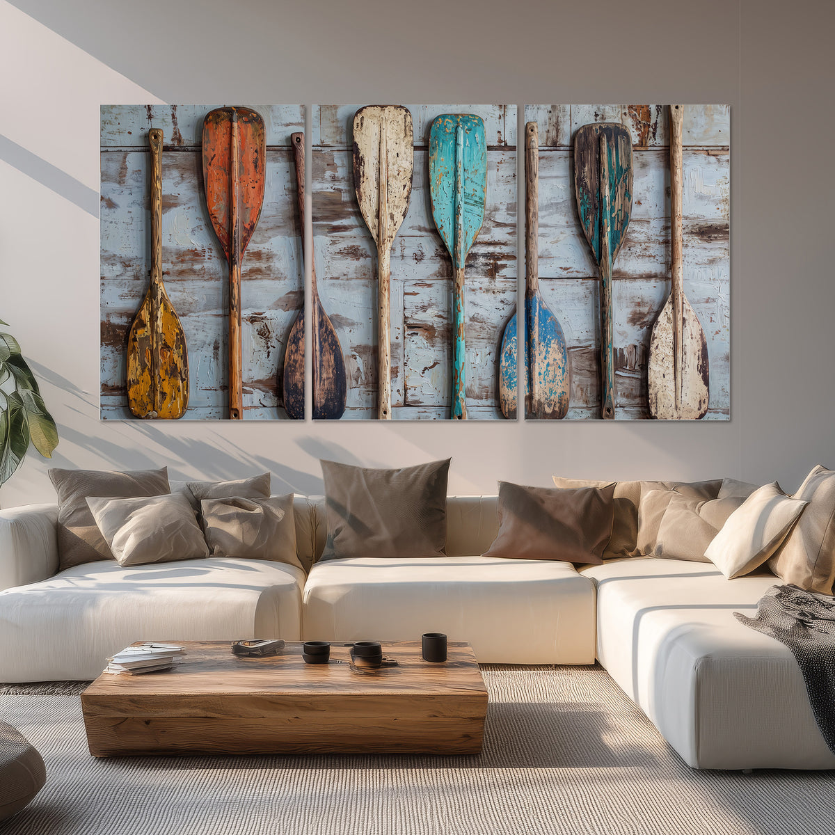 A row of colorful weathered wooden oars against pale blue boards set of 3 poster prints displayed in a living room
