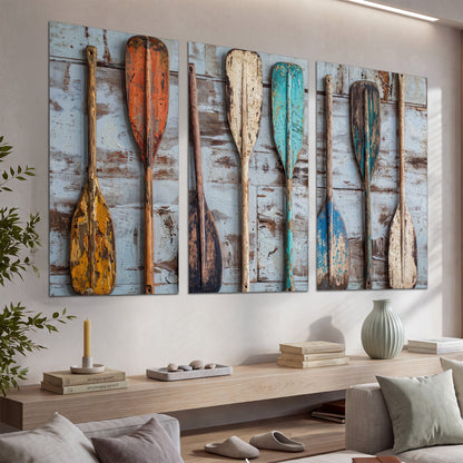 A row of colorful weathered wooden oars against pale blue boards set of 3 poster prints displayed in a console