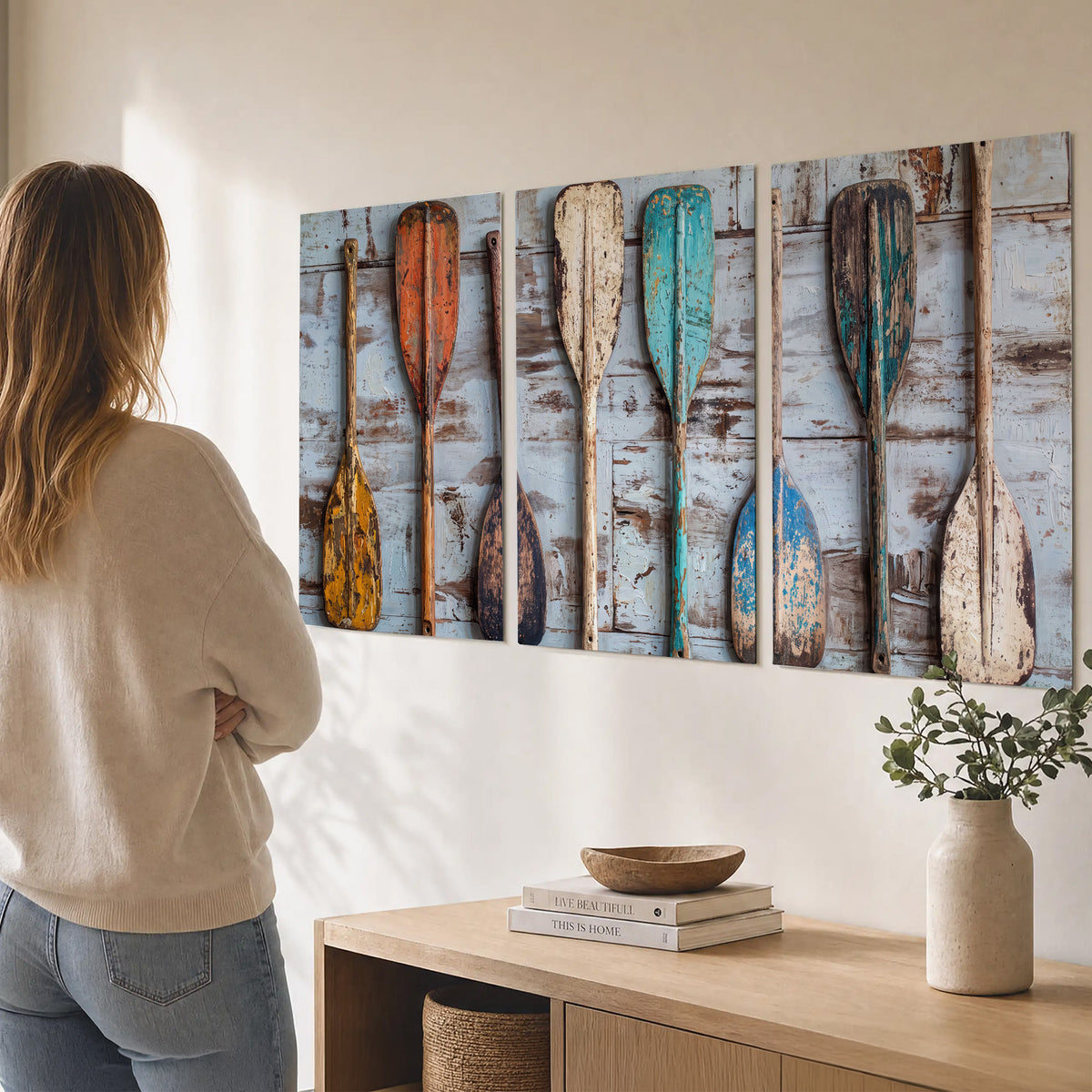 A row of colorful weathered wooden oars against pale blue boards set of 3 poster prints three panel arrangement on a wall