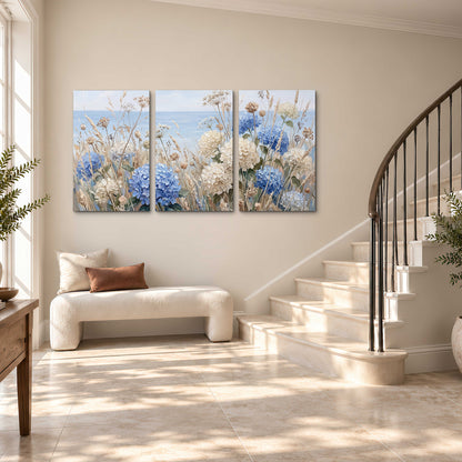 Blue hydrangeas and delicate ivory wildflowers beneath a pale blue sky 3 piece canvas wall art styled in an interior