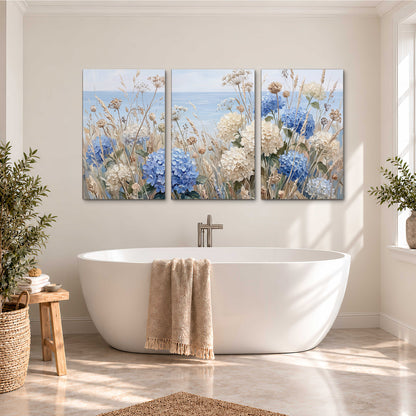 Blue hydrangeas and delicate ivory wildflowers beneath a pale blue sky 3 piece canvas wall art styled in an interior