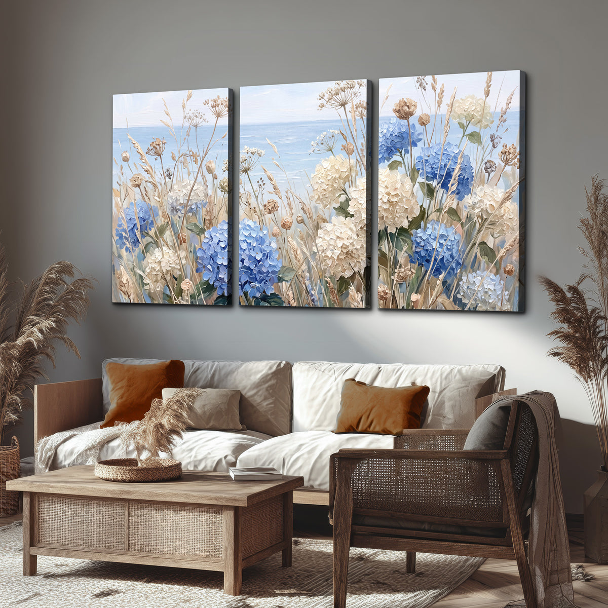 Blue hydrangeas and delicate ivory wildflowers beneath a pale blue sky 3 piece canvas wall art displayed in a rustic living room