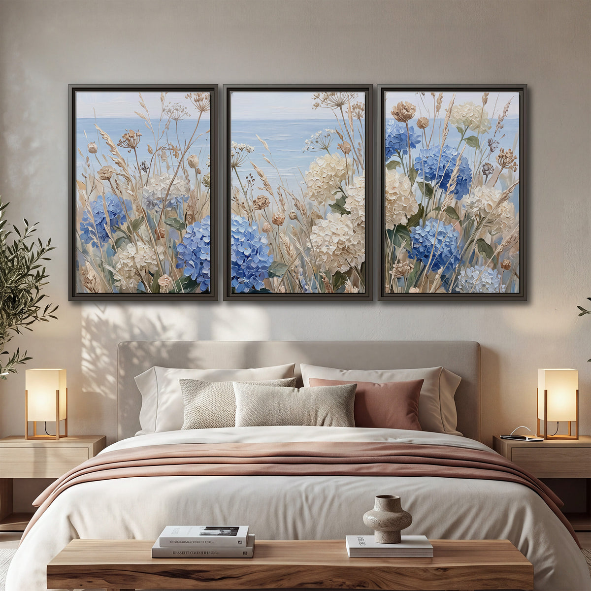 Blue hydrangeas and delicate ivory wildflowers beneath a pale blue sky 3 piece framed canvas wall art displayed in a bedroom