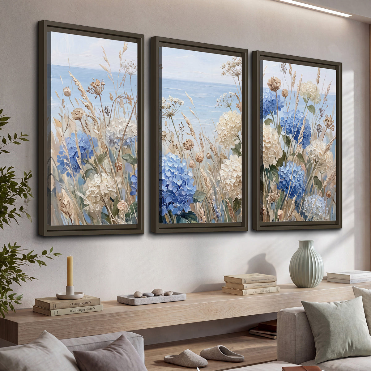 Blue hydrangeas and delicate ivory wildflowers beneath a pale blue sky 3 piece framed canvas wall art displayed in a console