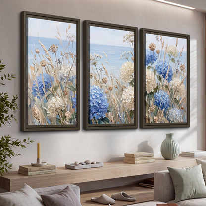 Blue hydrangeas and delicate ivory wildflowers beneath a pale blue sky 3 piece framed canvas wall art displayed in a console
