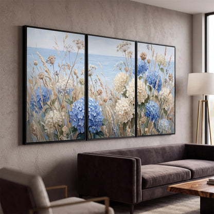 Blue hydrangeas and delicate ivory wildflowers beneath a pale blue sky 3 piece framed canvas wall art displayed in a modern living room