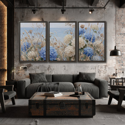Blue hydrangeas and delicate ivory wildflowers beneath a pale blue sky 3 piece framed canvas wall art displayed in a industrial room