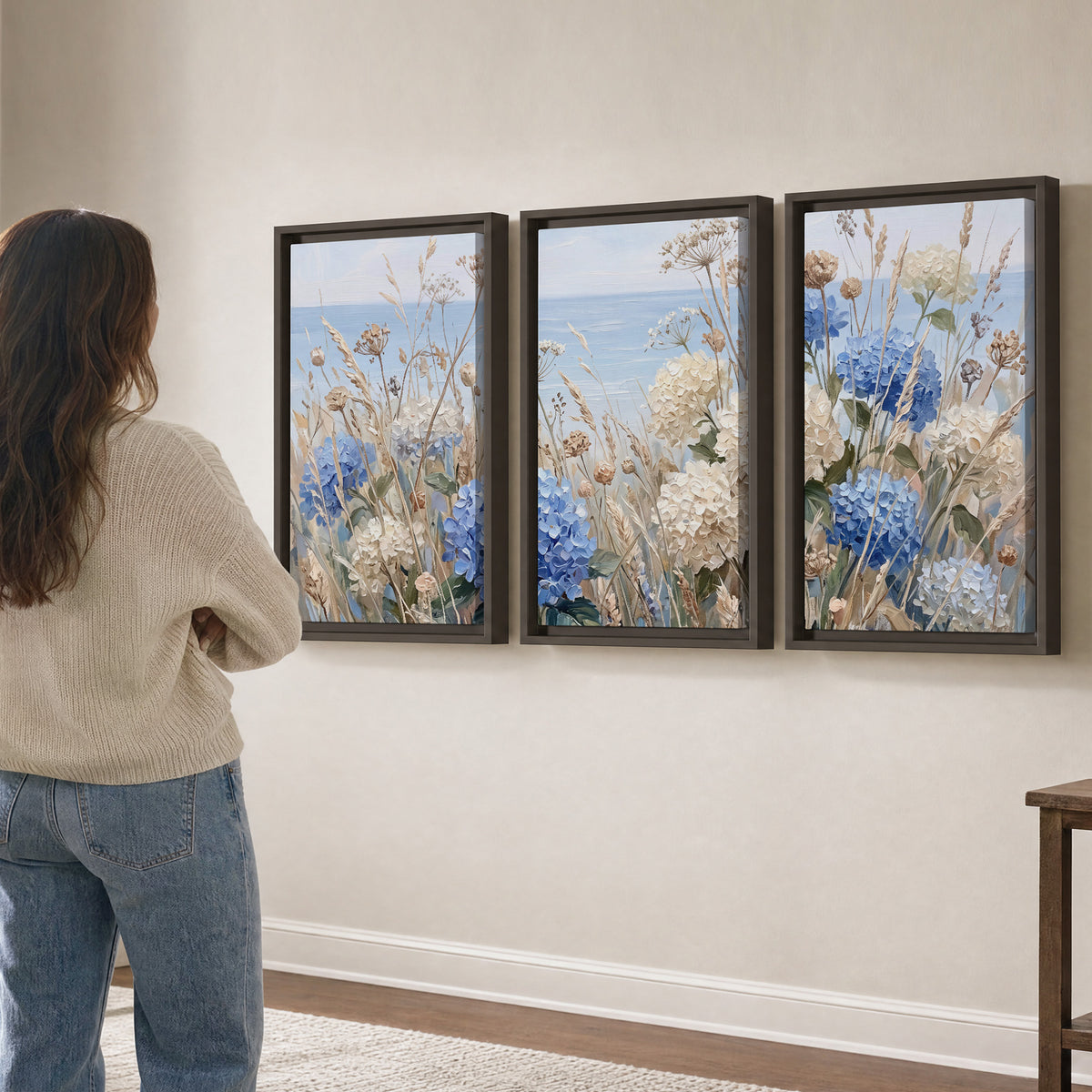 Blue hydrangeas and delicate ivory wildflowers beneath a pale blue sky 3 piece framed canvas wall art three panel arrangement on a wall